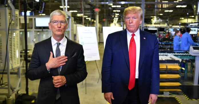 US President Donald Trump (r) and Apple CEO Tim Cook speak to the press during a tour of the Flextronics computer manufacturing facility where Apple’s Mac Pros are assembled in Austin, Texas, on November 20, 2019.